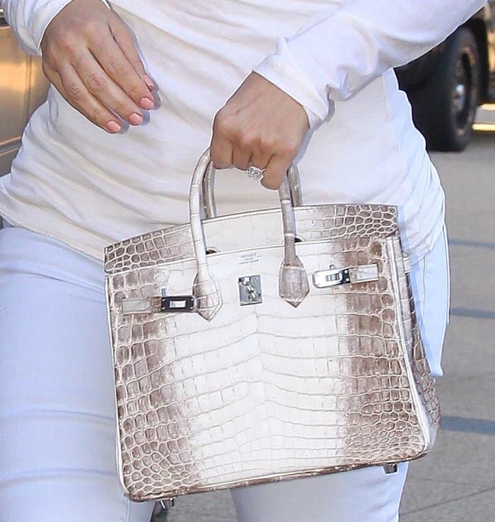 A closer look at Kim Kardashian’s ultra-rare mini Hermès Birkin, crafted from white crocodile leather with a subtle ombré finish—one of the most coveted luxury bags in the world