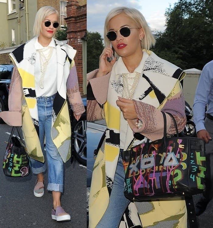 Rita Ora turns heads in a bold patchwork coat, cuffed jeans, and slip-on sneakers, accessorizing with a graffiti-covered Birkin bag outside The Grove Music Studios in London on August 13, 2014