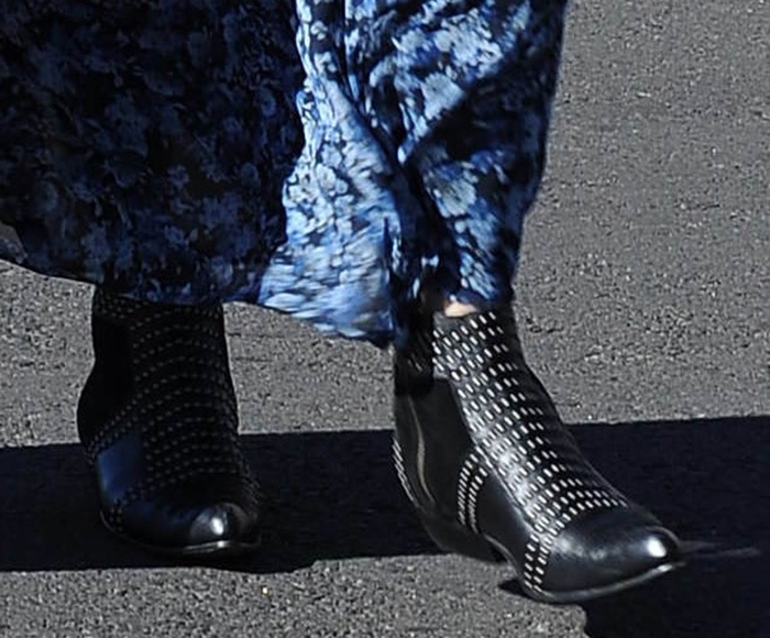 Close-up of Emma Roberts wearing black Anine Bing studded Western ankle boots with pointed toes