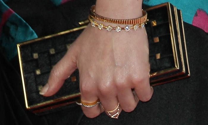 Gillian Jacobs completes her red-carpet look with a sleek black Rodo clutch framed in gold hardware