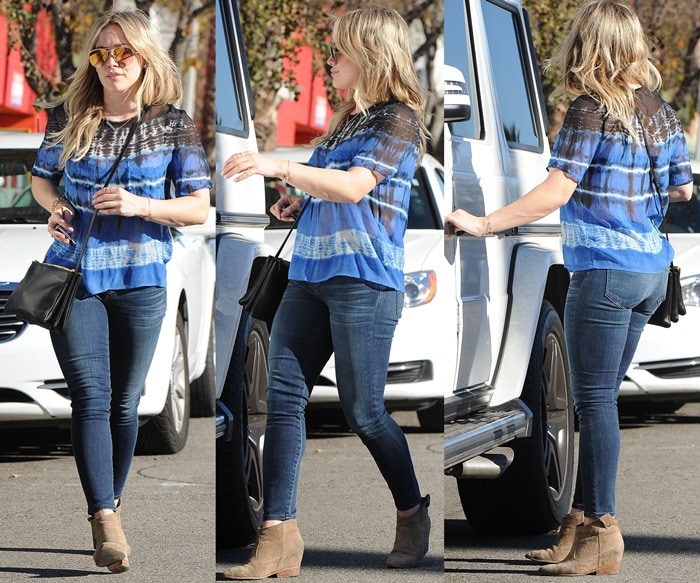 Hilary Duff perfects casual street style in a breezy tie-dye blouse, dark skinny jeans, and suede ankle booties, effortlessly blending comfort with chic
