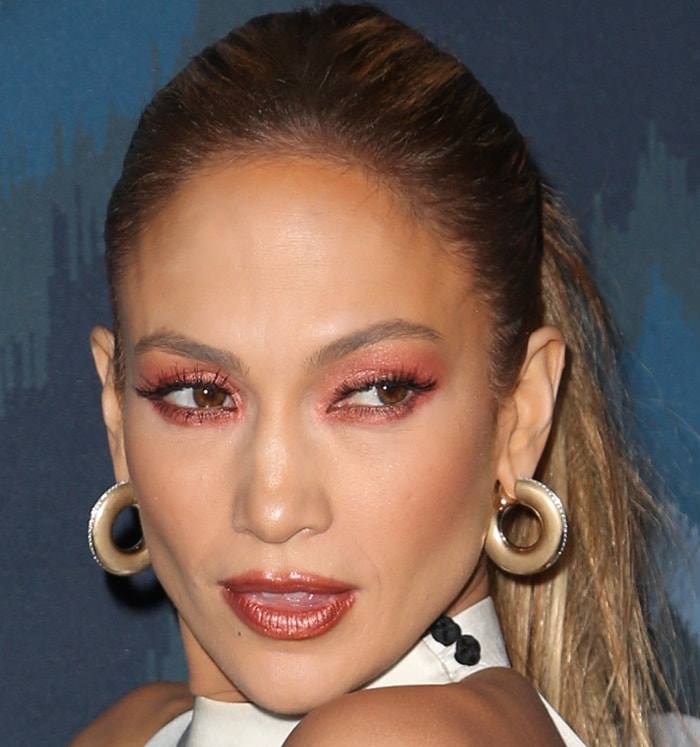 Jennifer Lopez swept her hair into a sleek ponytail and paired warm copper-toned makeup with oversized gold hoop earrings at the 2015 Winter TCA Tour in Pasadena