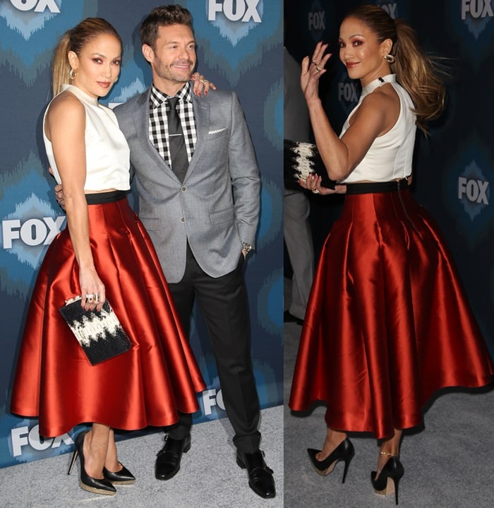 Jennifer Lopez brought retro-inspired glamour to the 2015 Winter TCA Tour in a dramatic rust satin midi skirt, a cropped white halter top, and towering Charlotte Olympia platform pumps alongside Ryan Seacrest