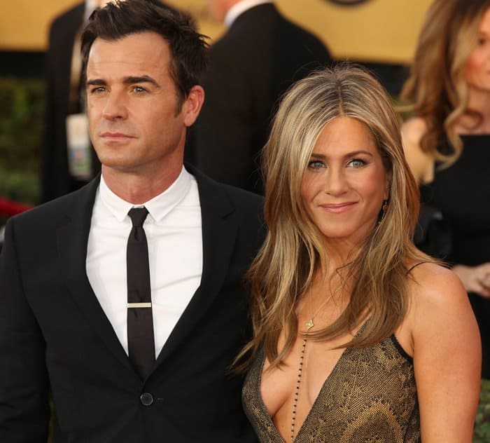 Jennifer Aniston and Justin Theroux make a polished red-carpet pairing, with her deep-V Galliano gown contrasting his classic black suit