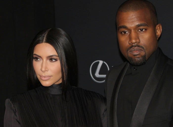 Kim Kardashian and Kanye West pose in coordinated black Balmain outfits at the 2015 BET Honors