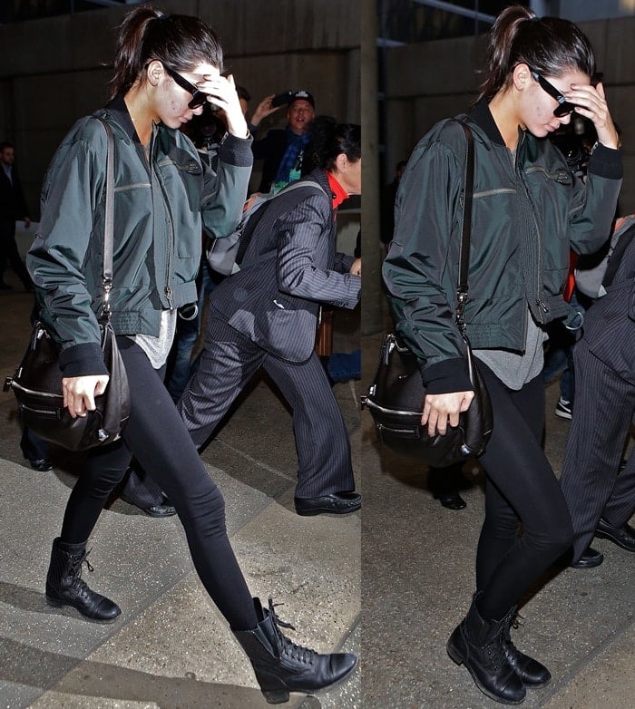Kendall Jenner steps out in a stylish ensemble featuring a gray T-shirt, black leggings, and a bomber jacket from HM