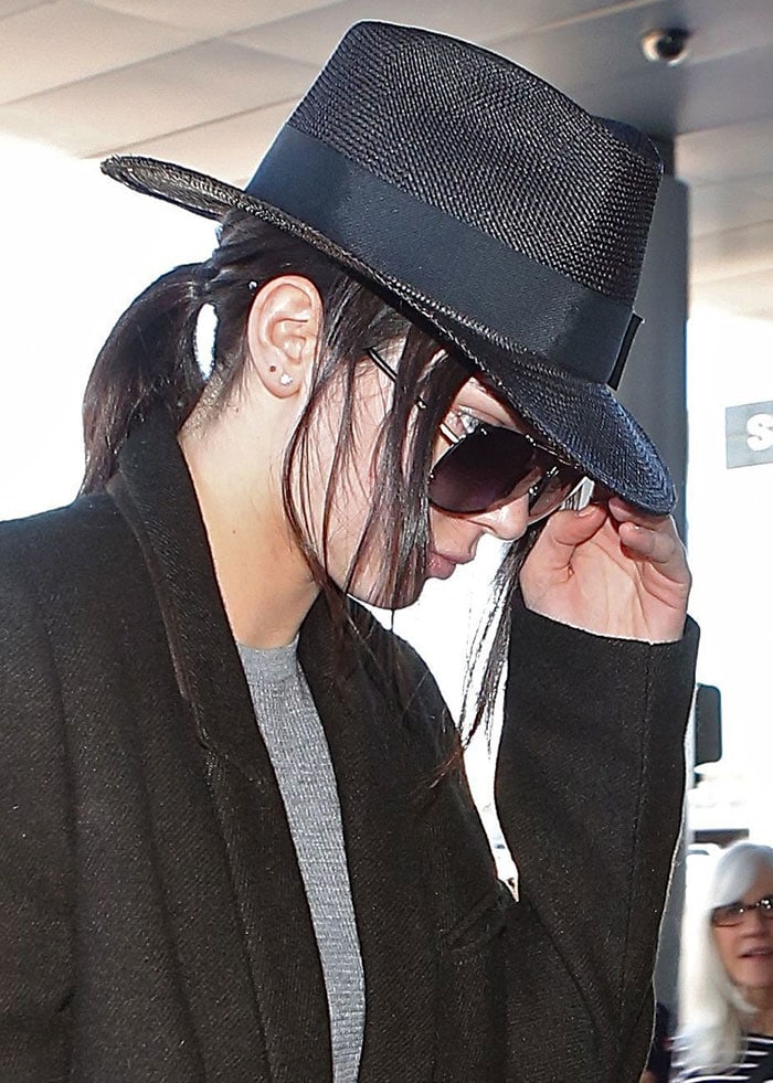 Kendall Jenner's fedora hat and trench coat by Haider Ackermann