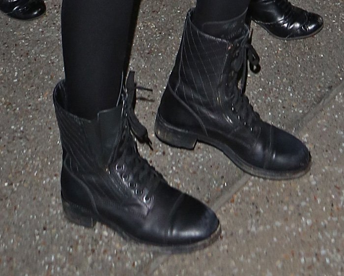 Kendall Jenner's footwear choice features black lace-up quilted leather combat boots from Chanel