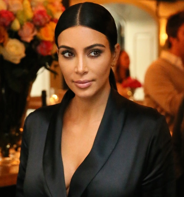 Kim Kardashian with her signature slicked-back hair and soft makeup