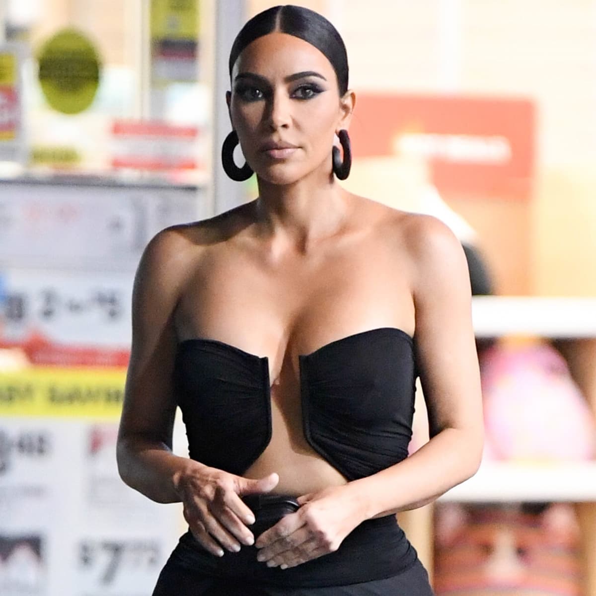 Kim Kardashian commands attention with sleek, sculpted eyeliner and statement Balenciaga hoops, adding edge to her strapless Rick Owens gown