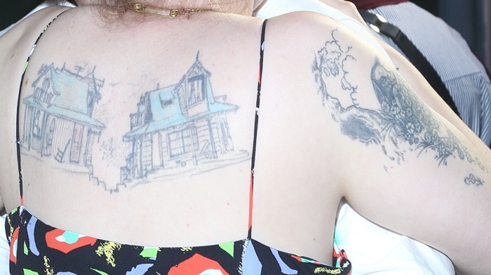 Dunham showed the same two-house tattoo at the 2017 Tokyo Project premiere, offering a closer look at the detailed illustration and weathered colorwork