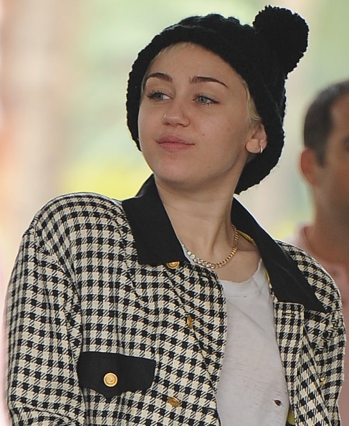 Miley Cyrus's white houndstooth vintage jacket and cat ears beanie