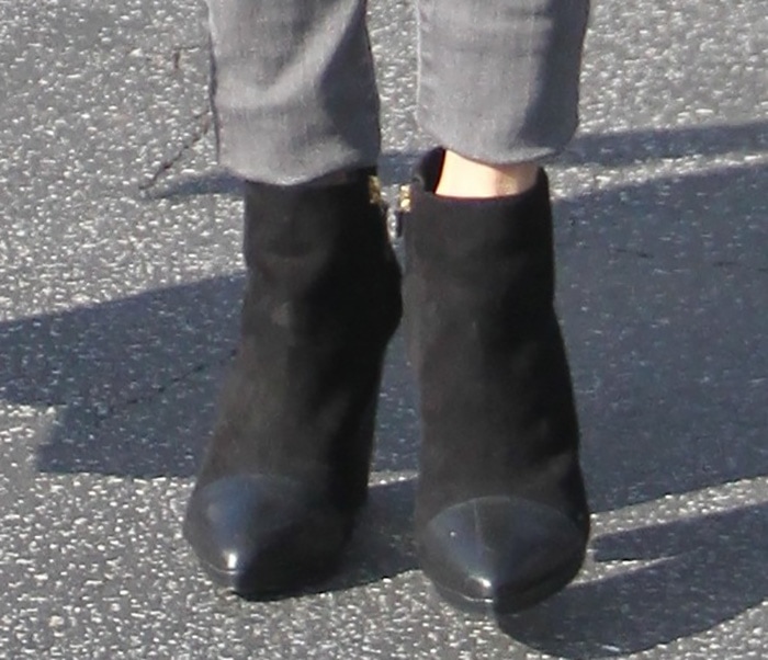 Close-up of Nikki Reed’s Tory Burch ‘Rivington’ ankle boots, crafted in black suede with pointed leather toe caps and sturdy block heels