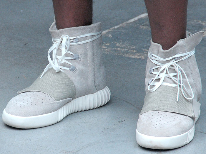 The Adidas Originals x Kanye West Yeezy "750 Boost" sneakers on a model