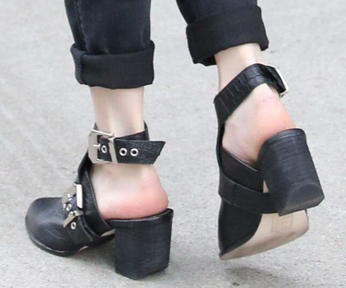 Emma Roberts pairs her cuffed black skinny jeans with the chic and versatile Sol Sana booties
