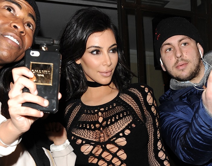 Kim Kardashian shows off her flawless makeup and dramatic eye look while posing with fans at the 2015 BRIT Awards in London