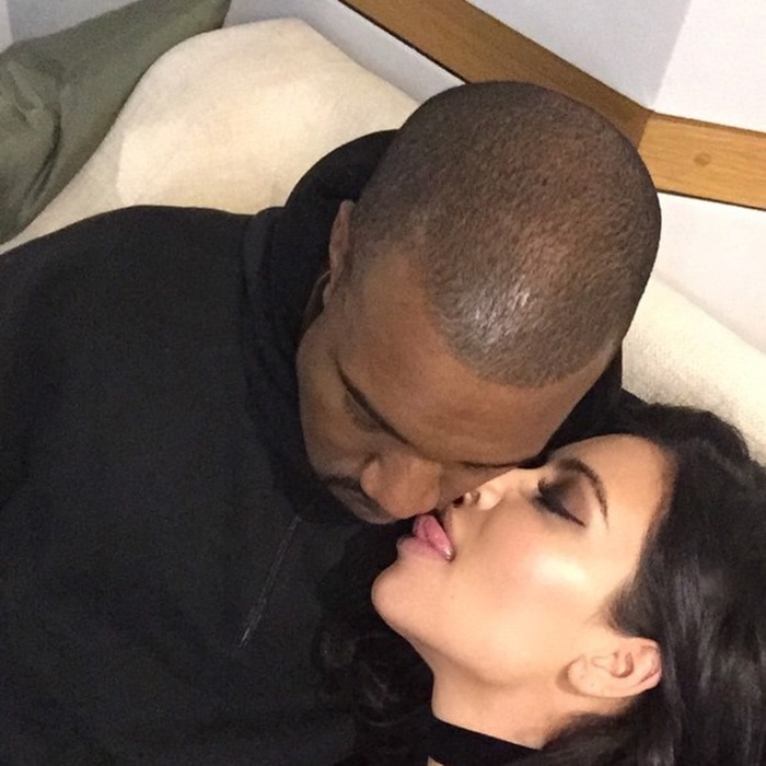 Kim Kardashian shares an intimate moment with Kanye West, showcasing her glamorous makeup and glowing skin
