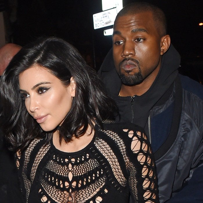 Kim Kardashian, wearing a revealing black Julien MacDonald jumpsuit, with Kanye West at the 2015 BRIT Awards in London