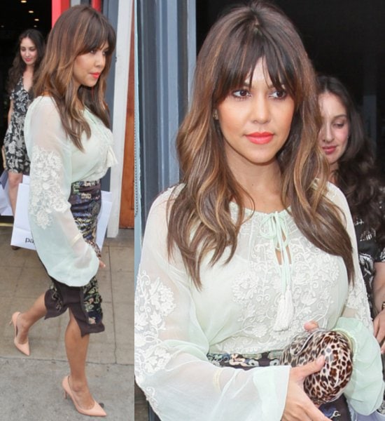 Kourtney Kardashian elegantly sports a Gold Hawk embroidered floral peasant blouse and totes a Kardashian Kollection leopard print resin clutch