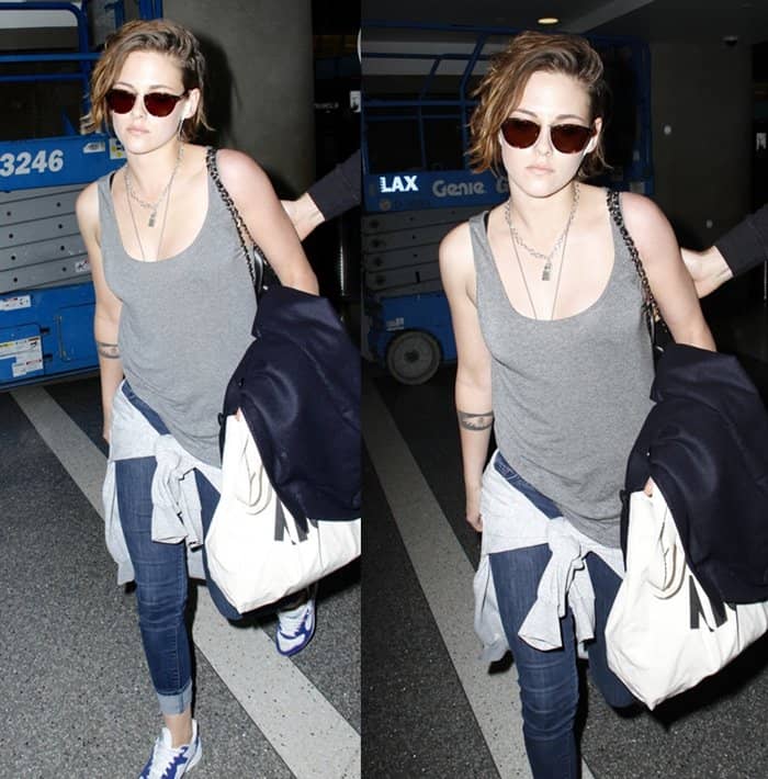 Kristen Stewart effortlessly rocks a casual chic look at LAX, pairing a gray tank top with skinny jeans, sneakers, and her signature "Punk Lock" necklace