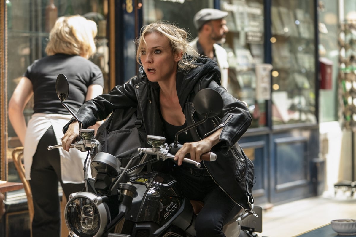 Diane Kruger embodies fierce action-hero energy in The 355, sporting an edgy black leather jacket while making a daring getaway on a motorcycle