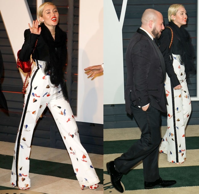 Miley Cyrus strides confidently into the 2015 Vanity Fair Oscar Party wearing Schiaparelli heart-print trousers paired with towering, graphic platform heels that peek out beneath the flared hem