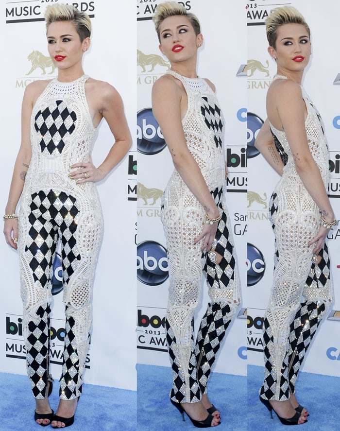 Miley Cyrus rocks a Balmain jumpsuit and Givenchy shoes on the blue carpet at the 2013 Billboard Music Awards held at the MGM Grand Garden Arena in Las Vegas on May 19, 2013
