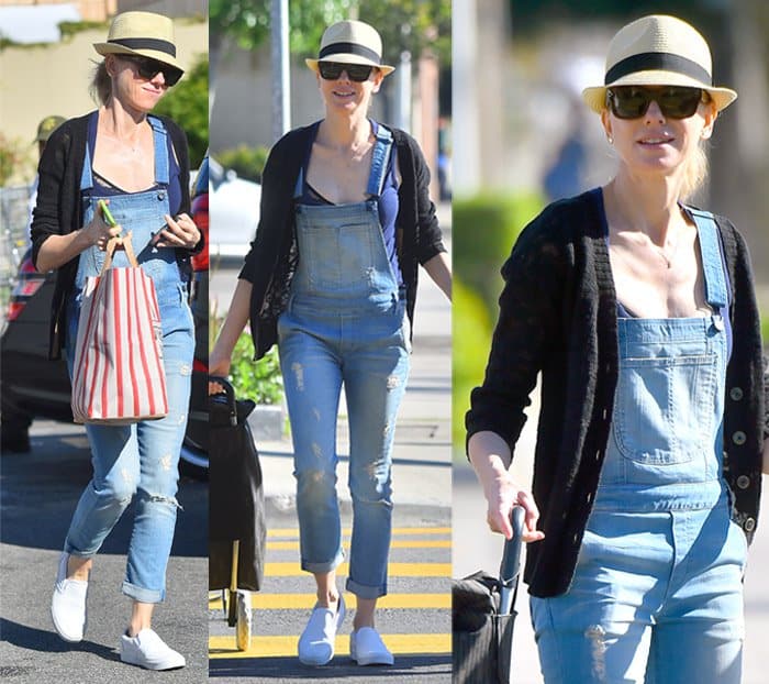 Naomi Watts gives denim overalls a grown-up twist by pairing them with crisp white slip-on sneakers and a lightweight black cardigan for an easy grocery run look