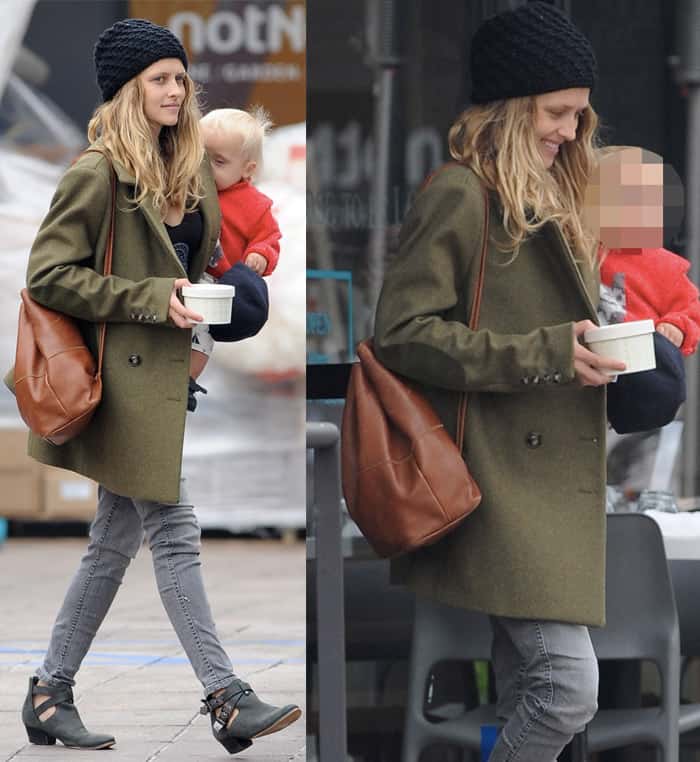 Teresa Palmer blends comfort and edge in cutout ankle boots, gray skinny jeans, and an oversized olive coat—delivering mom-on-the-go style with effortless polish