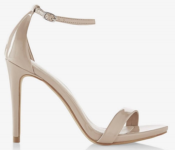 Express "Sleek Patent Runway Sandals" in nude patent leather feature minimalist toe and ankle straps with a slender stiletto heel, complementing Lauren Conrad's polished Lela Rose dress without overpowering its clean silhouette