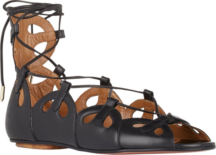 Aquazzura’s “J’Adore” sandals feature a sculptural series of teardrop cutouts and delicate wraparound laces, giving the classic flat a refined, feminine edge