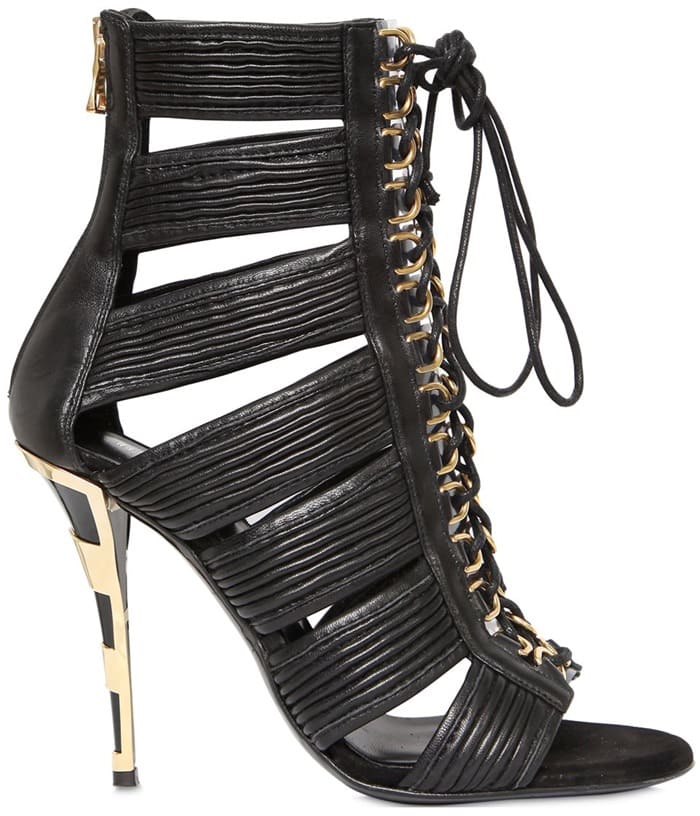 The Balmain 110 mm “Hopi” leather cage sandals — crafted in Italy with bold cutouts, gold hardware, and a sculptural stiletto heel