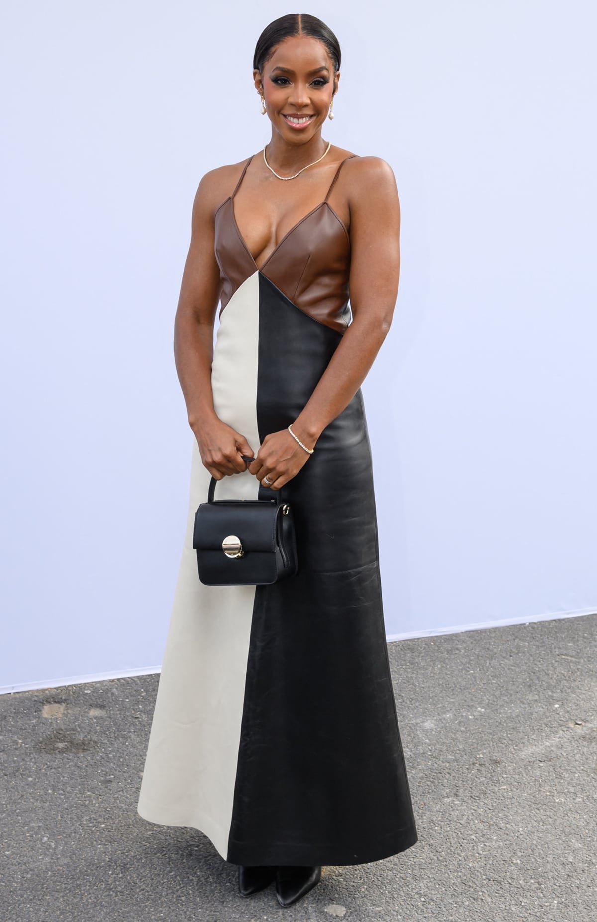 Kelly Rowland stuns in a chic color-blocked leather gown while attending the Chloé Womenswear Spring/Summer 2024 show during Paris Fashion Week