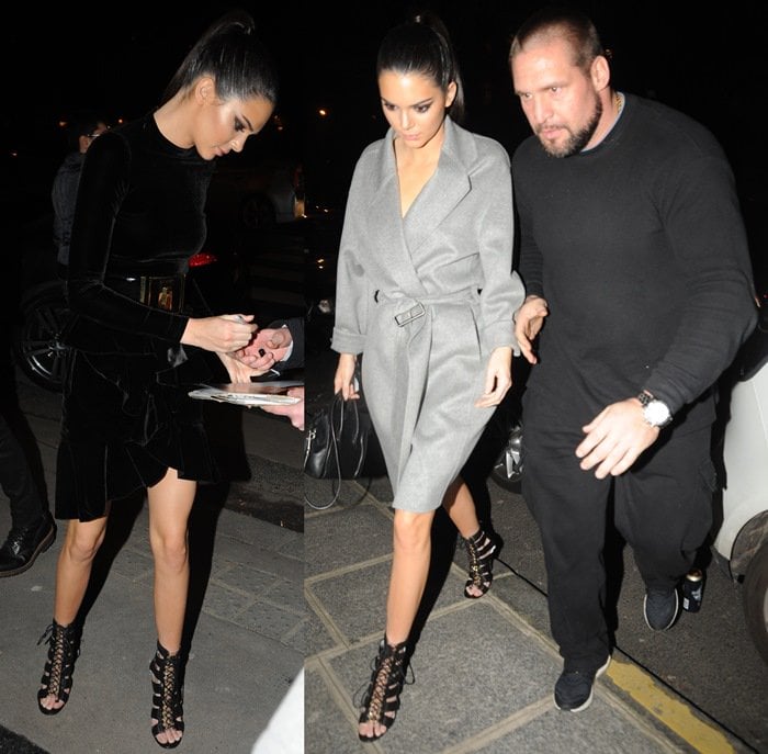 Kendall Jenner steps out in Paris wearing a black velvet Balmain Fall 2015 look with a chunky waist-cinching belt, later layering on a belted gray coat—all styled with statement-making Balmain “Hopi” leather cage sandals