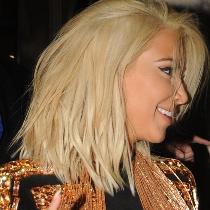 Kim Kardashian debuted a striking platinum blonde bob while wearing a gold-fringed Balmain Pre-Fall 2015 jacket in Paris