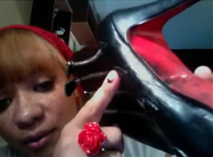 YouTuber Phoenix1018 points to the visible glue stains and leather damage left by a cobbler who botched her brand-new pair of Christian Louboutin booties