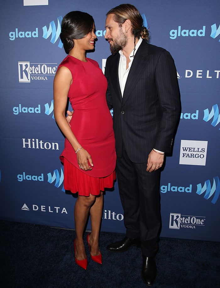 Zoe Saldaña dazzles in a red Cushnie et Ochs two-tone dress paired with matching Kurt Geiger pumps, while Marco Perego keeps it sharp in a classic black pinstripe suit at the 2015 GLAAD Media Awards