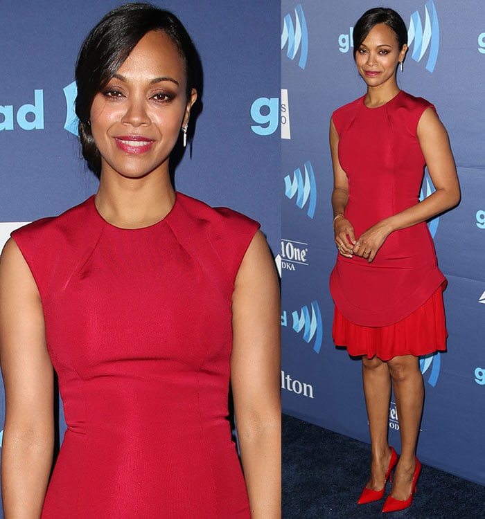 Zoe Saldaña pairs her bold two-tone red Cushnie et Ochs dress with matching Kurt Geiger pumps, minimal jewelry, and a sleek side-parted bun, creating an effortlessly chic look