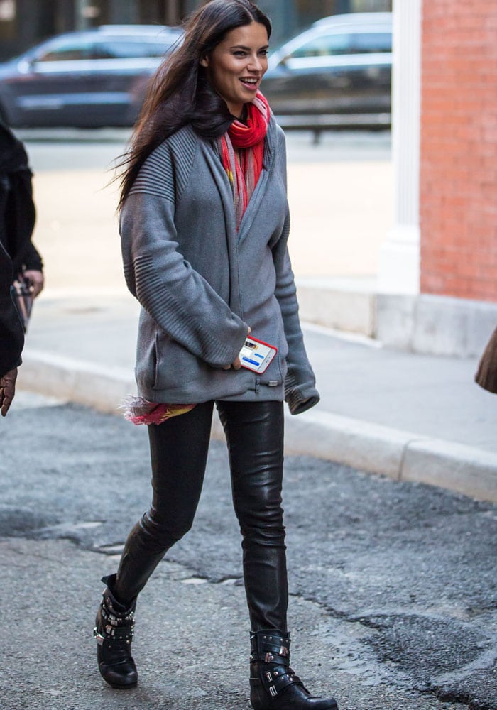 Adriana Lima showcased her off-duty style, pairing her black leather pants with a gray sweater and a pair of edgy buckled black boots