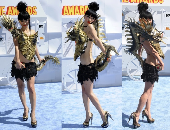 Balancing on custom metallic platform pumps, Bai Ling fully embraced the theatrical silhouette of her dragon-inspired ensemble from every angle
