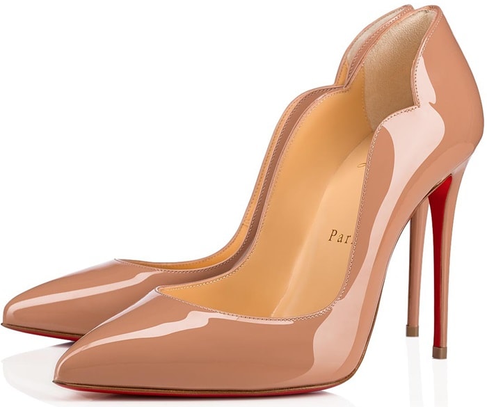 A curvy, scalloped counter and willowy stiletto heel dial up the drama on a pointy-toe pump finished with that iconic red sole