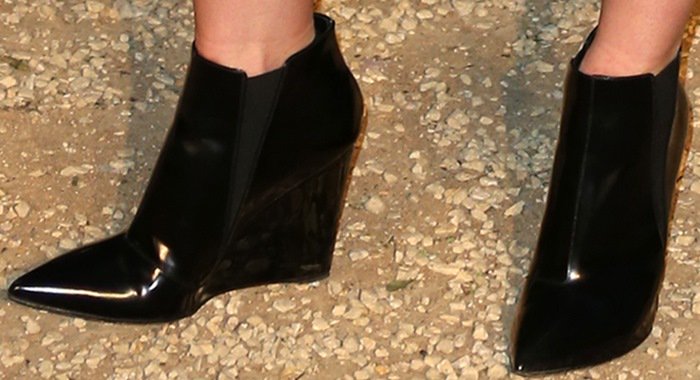 Jaime King completes her ensemble with sharp, high-gloss black wedge ankle boots featuring pointed toes