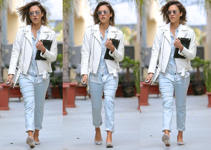 Jessica Alba walks with relaxed confidence, pairing cuffed light-wash jeans with silver ballet flats that subtly catch the light