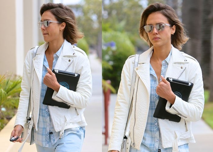 A closer view highlights her crisp white textured jacket layered over a pale blue plaid shirt for an easy daytime balance
