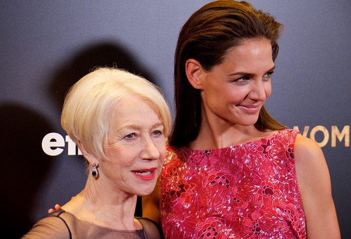 Katie Holmes towers over co-star Helen Mirren, with their height difference accentuated by Katie’s heels and upright posture