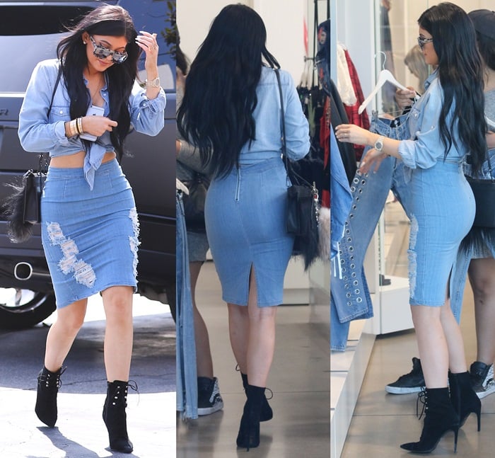 Kylie Jenner wears a double-denim look, pairing a cropped shirt with a distressed denim pencil skirt and black lace-up booties