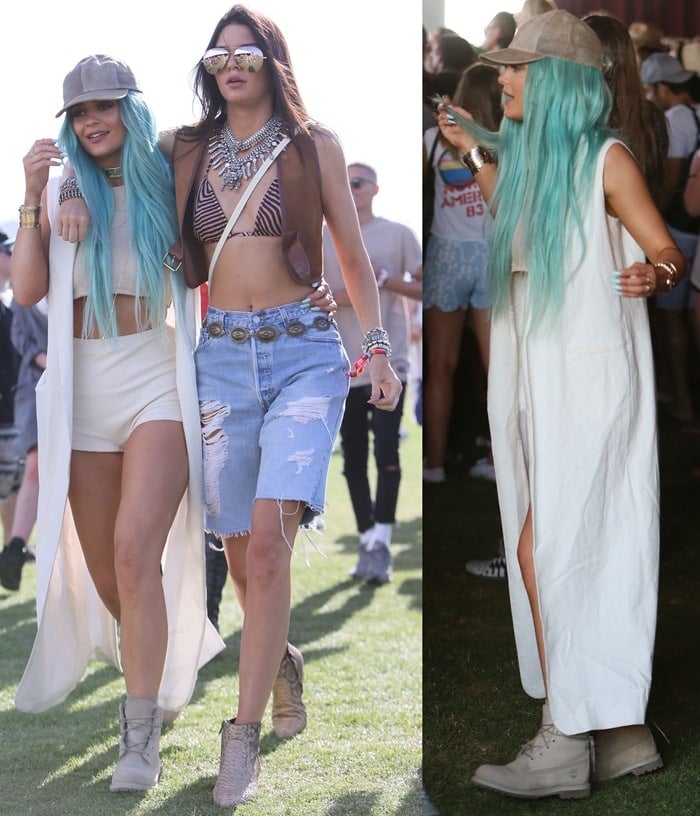 Pictured at Coachella 2015, Kylie Jenner showcases her aqua hair and a long waistcoat, completing her look with flat lace-up Timberland boots, alongside her sister Kendall Jenner