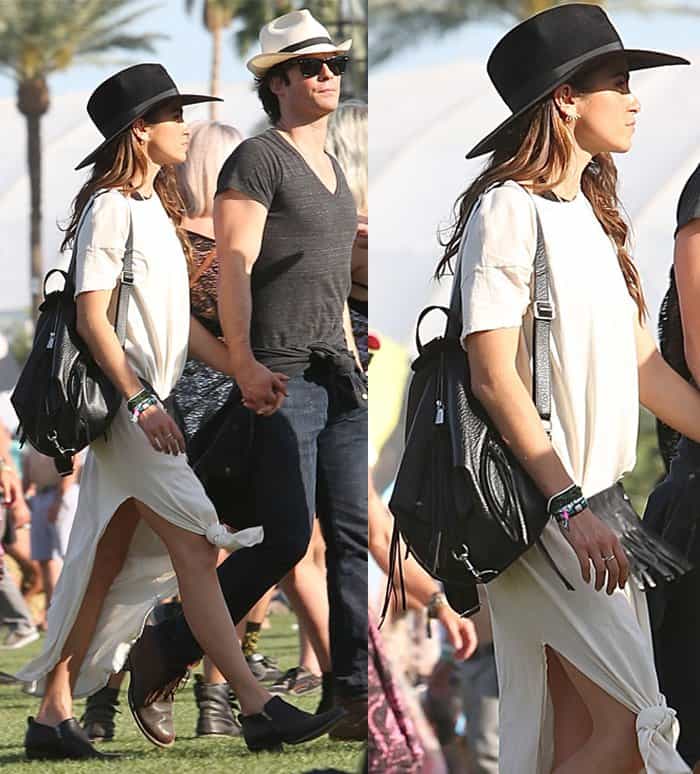 Nikki Reed exudes casual cool in a knotted hem white dress, accessorized with a black wide-brim hat and a matching backpack, while strolling at Coachella 2015