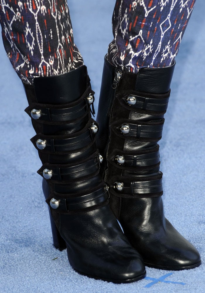 Shailene Woodley’s Isabel Marant boots featured a bold, high-cut silhouette with stacked buckled straps and silver dome studs, blending edge with Parisian flair
