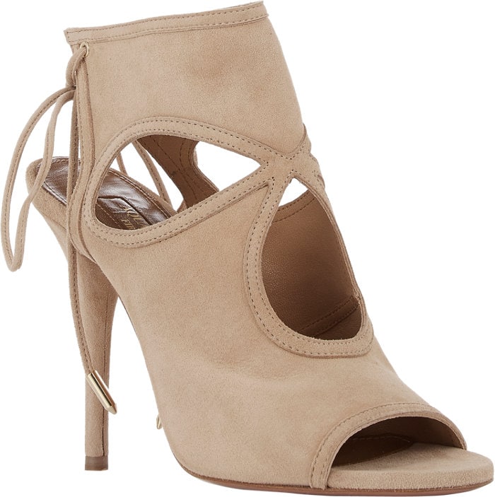 Aquazzura’s signature “Sexy Thing” booties in nude suede, featuring cutout detailing and a sleek lace-up back that adds instant lift and versatility to any look